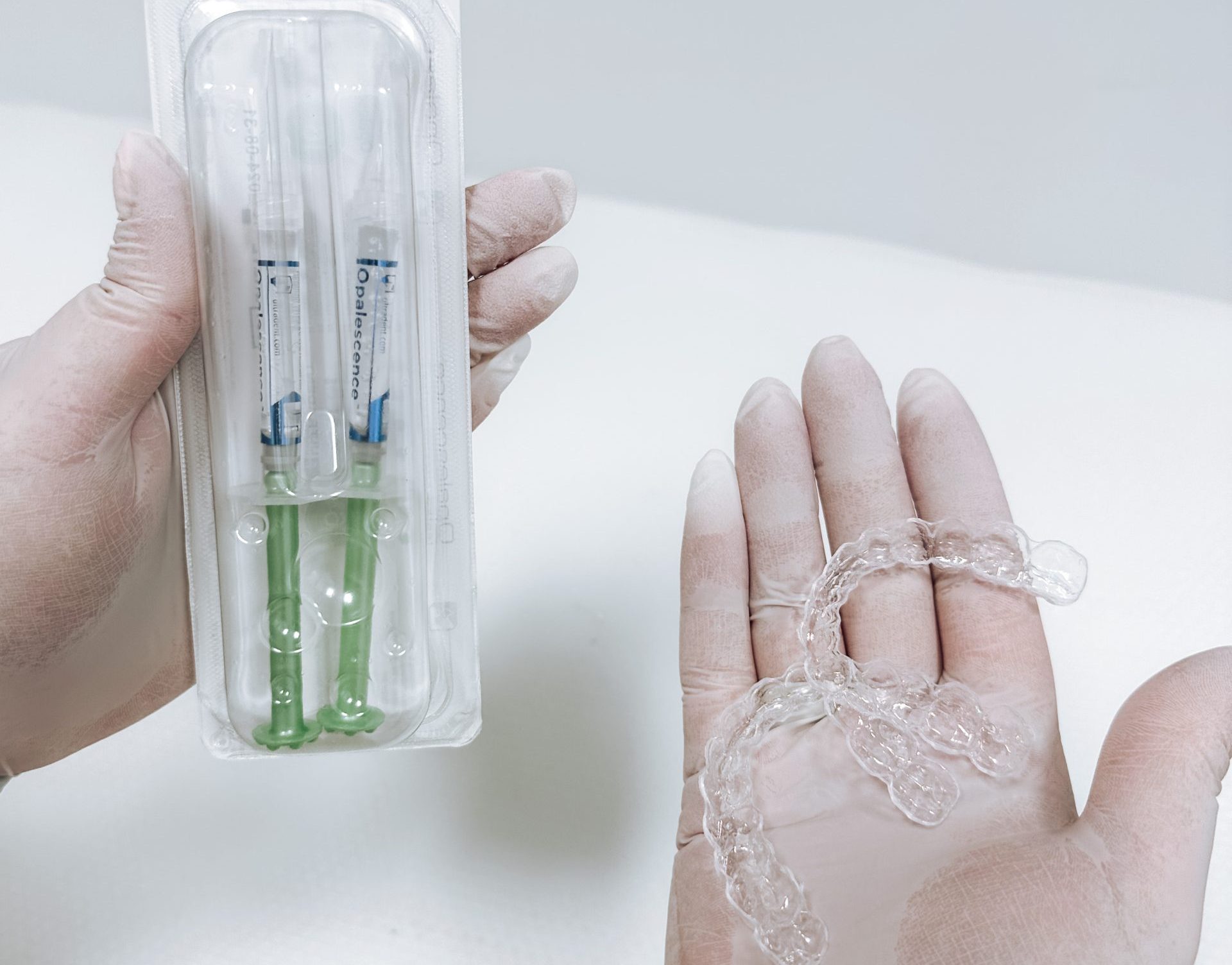 Dentist shows customized teeth whitening kit at OrthoDental