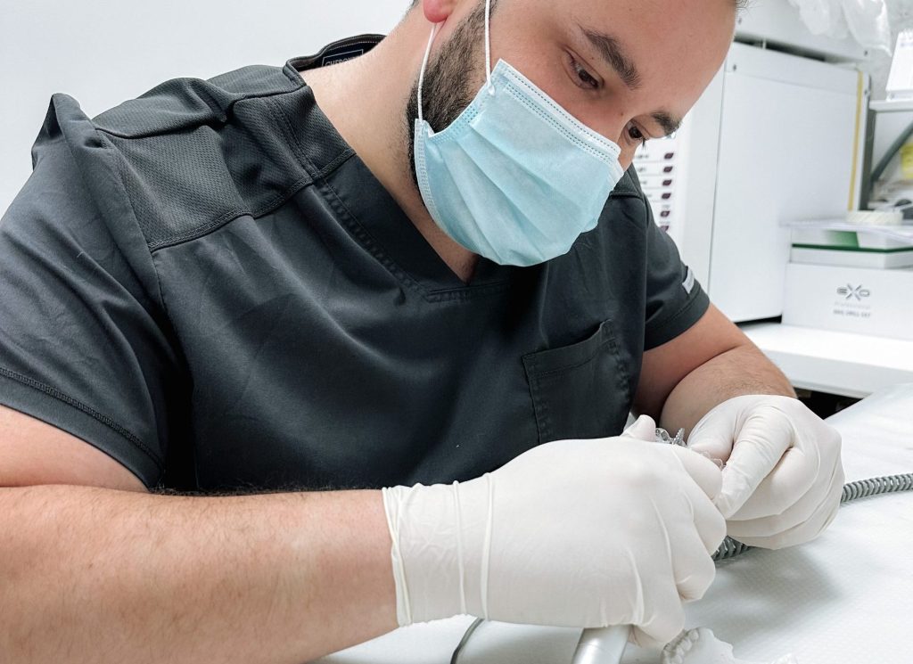 Dentist making teeth whitening kit for patient