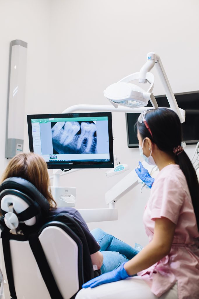 Dentist showing X-ray of wisdom tooth