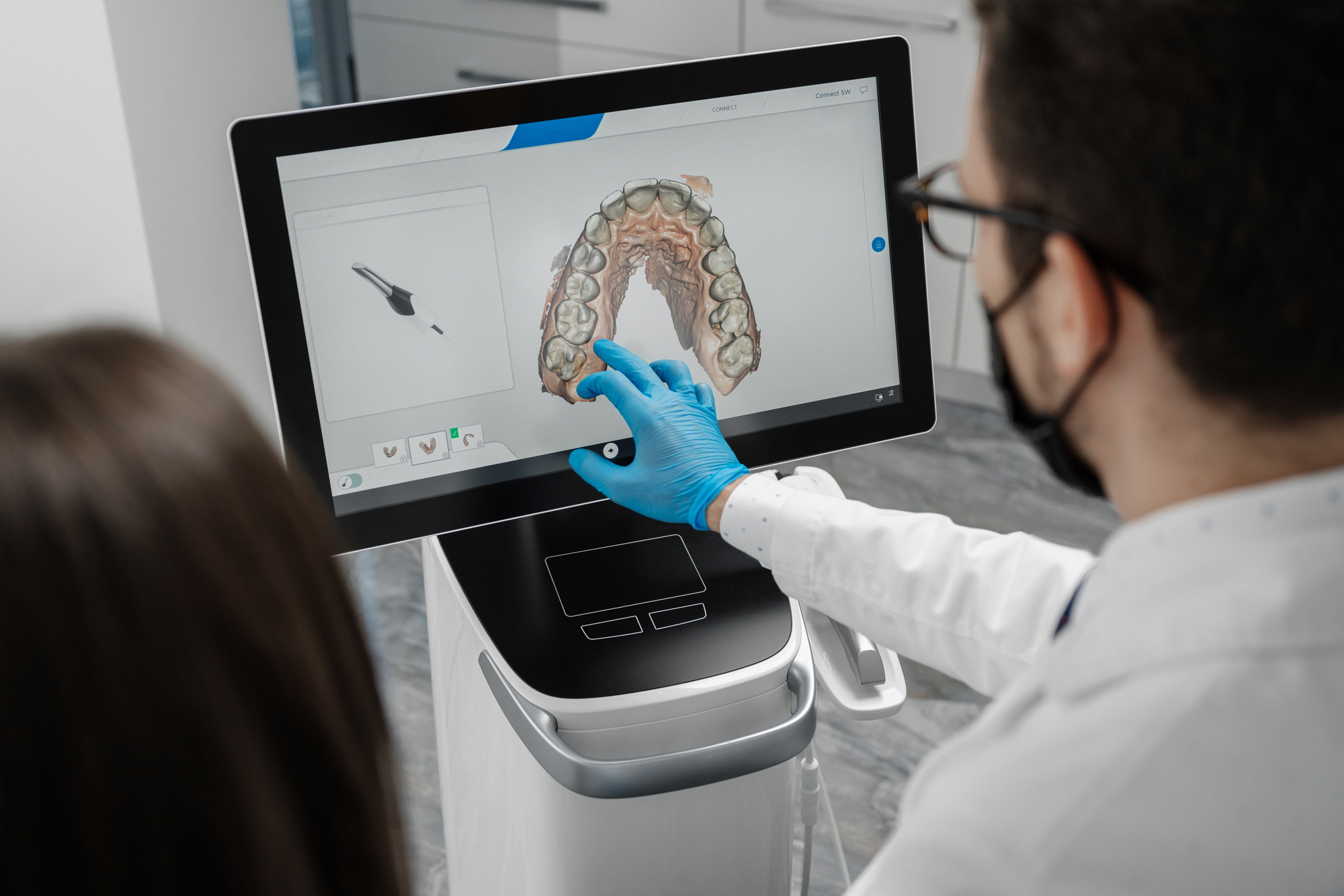Dentist making 3D scan of patient's teeth for full denture