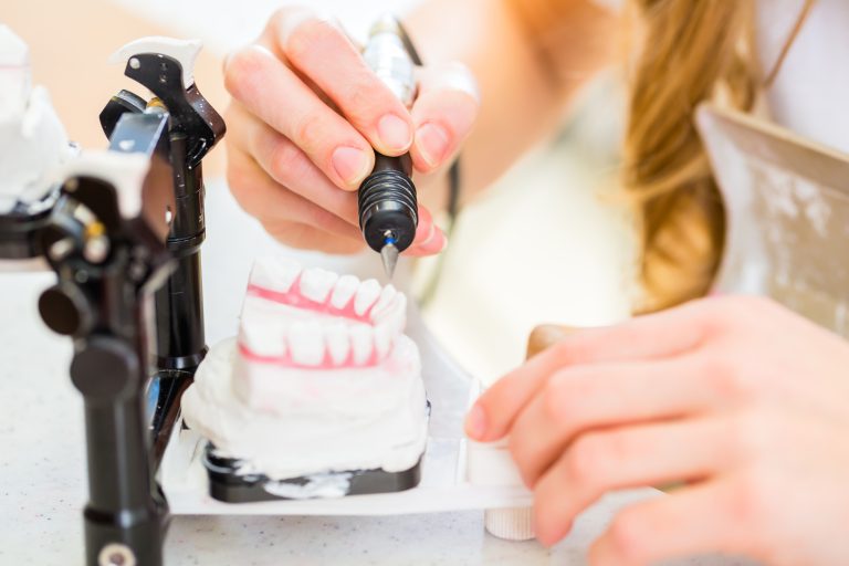 Dental technician making denture