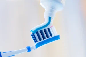 Fluoride toothpaste being applied to a toothbrush