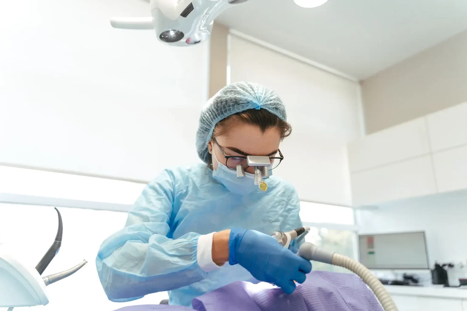 An oral surgeon removing an impacted wisdom tooth