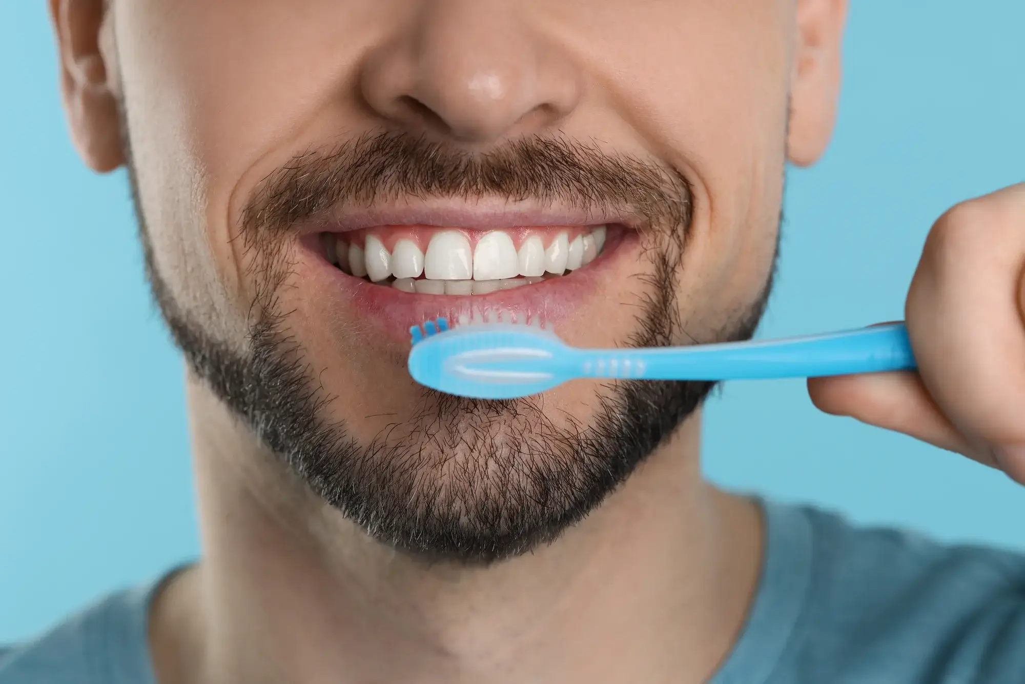 Person brushing their teeth correctly with a soft toothbrush